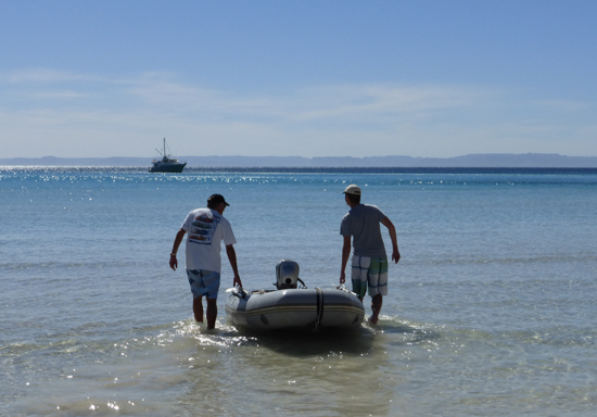 Captain Kurt and Chris heading out to our yacht, Endurance at Ensenada Grande cove. 