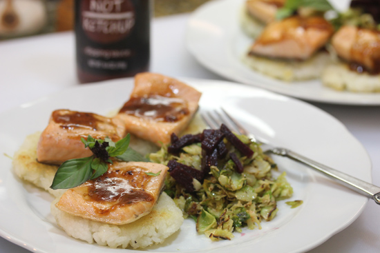Salmon on Crispy Rice Cakes topped with Smoky Date "Not Ketchup" and "Caesar" Brussels Sprouts. 