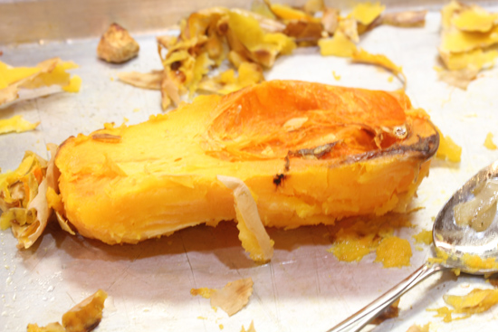 Cut off the papery skin from the butternut squash after roasting.