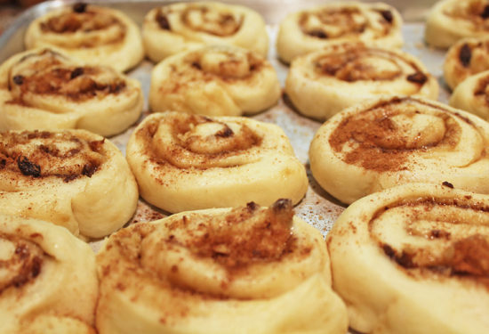Cinnamon Rolls after rising. They look puffy and have filled in the spaces. 