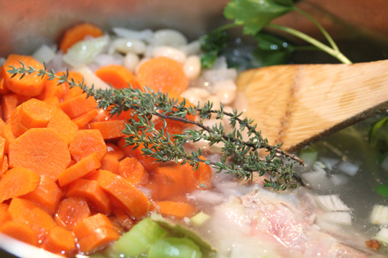 Start with mirepoix - onions, celery, carrots and the beans and ham bone. 