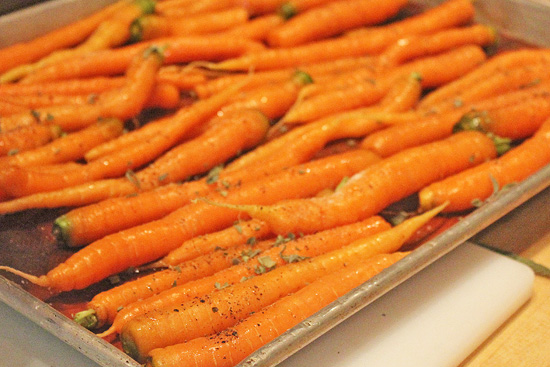 Fresh carrots with sage ready for the oven.